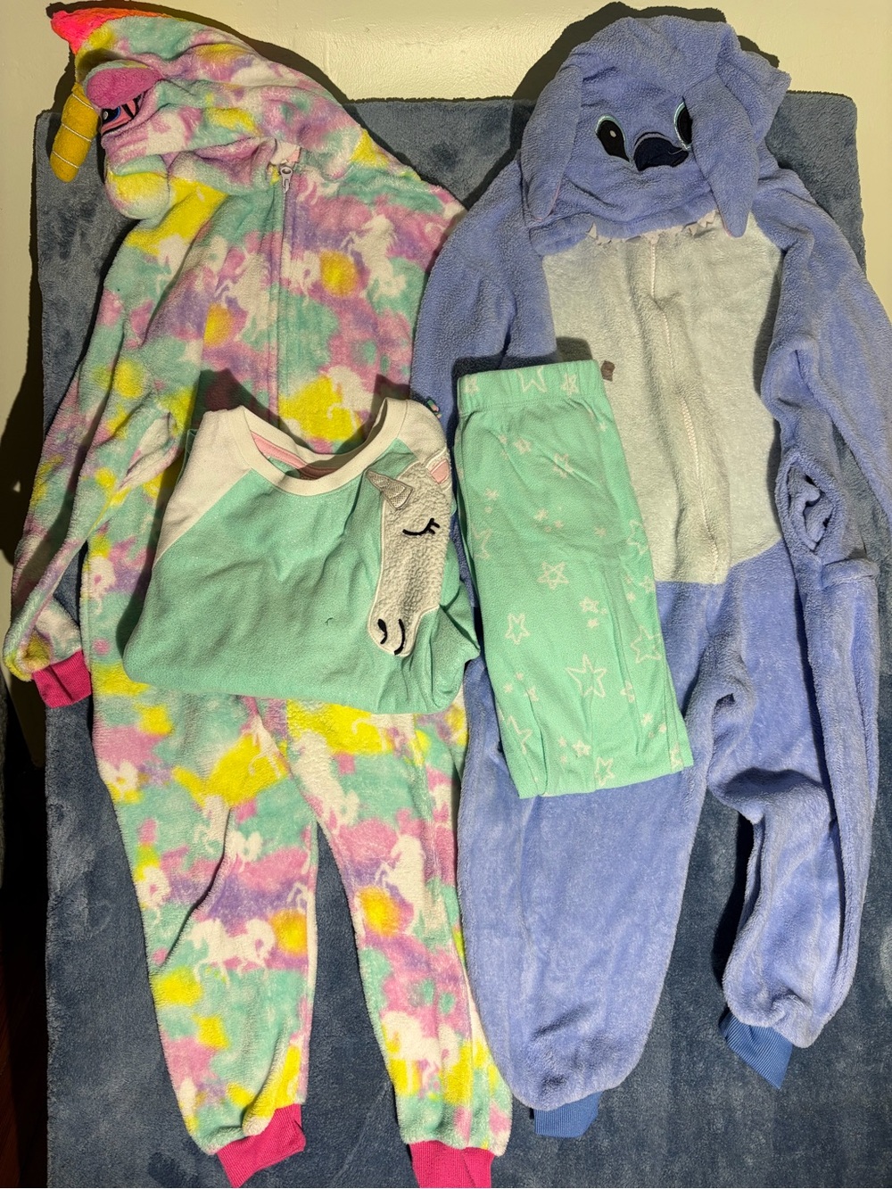 Unicorn and Lelo and Stitch onsie pajamas + unicorn two piece set.